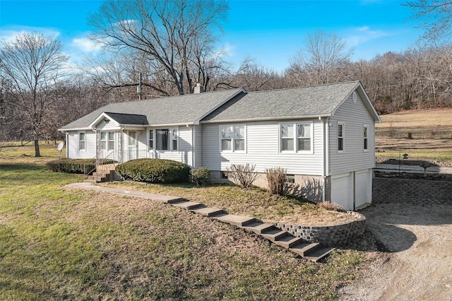 view of front of property featuring a front yard and a garage