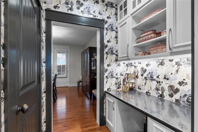 kitchen featuring white cabinets and dark wood-type flooring