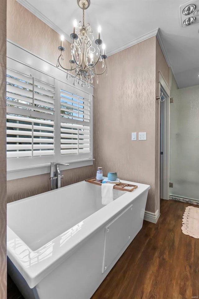 interior space with crown molding, plus walk in shower, an inviting chandelier, and hardwood / wood-style flooring