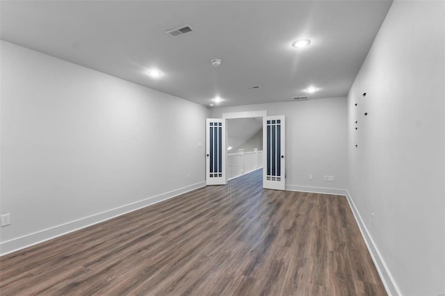 unfurnished room featuring dark wood-type flooring and french doors