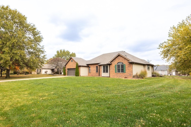 ranch-style home with a garage and a front lawn