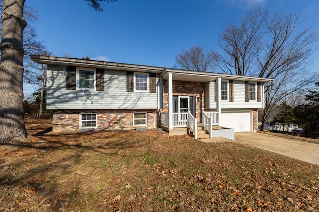 bi-level home featuring a garage and a front yard