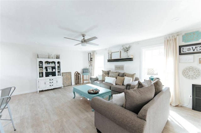 living room with light wood-type flooring and ceiling fan