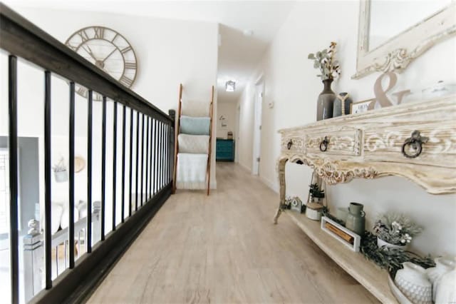 corridor with hardwood / wood-style flooring