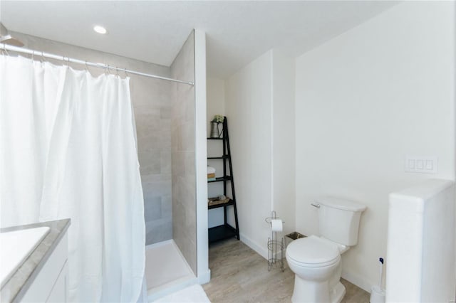 bathroom featuring a shower with curtain, toilet, vanity, and hardwood / wood-style flooring