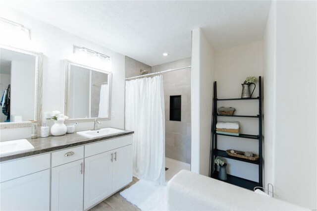 bathroom featuring a shower with shower curtain, wood-type flooring, and vanity