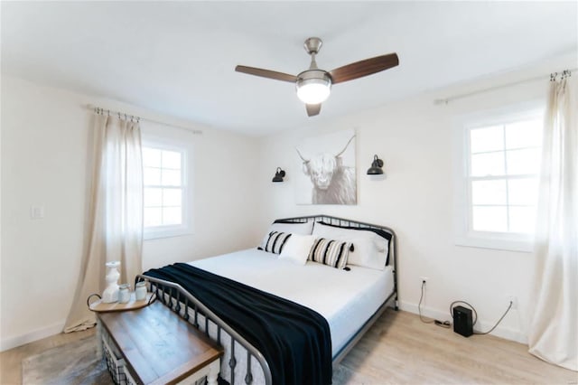 bedroom with light hardwood / wood-style floors and ceiling fan