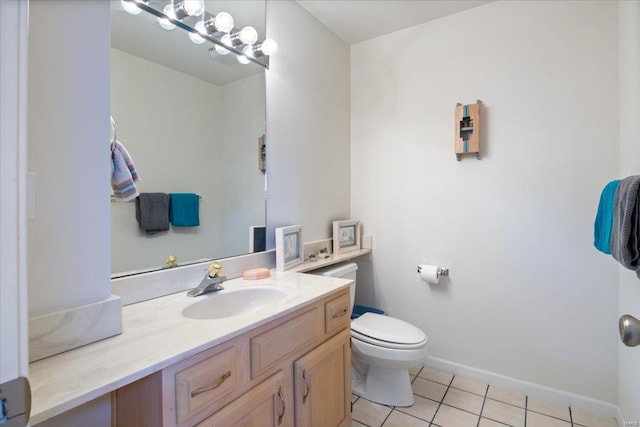 bathroom featuring vanity, tile patterned flooring, and toilet