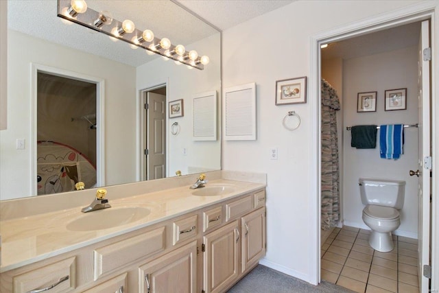 bathroom with vanity, tile patterned floors, and toilet