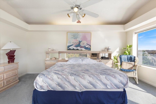 carpeted bedroom with ceiling fan and vaulted ceiling