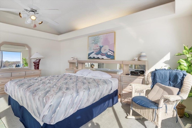 carpeted bedroom with ceiling fan and vaulted ceiling