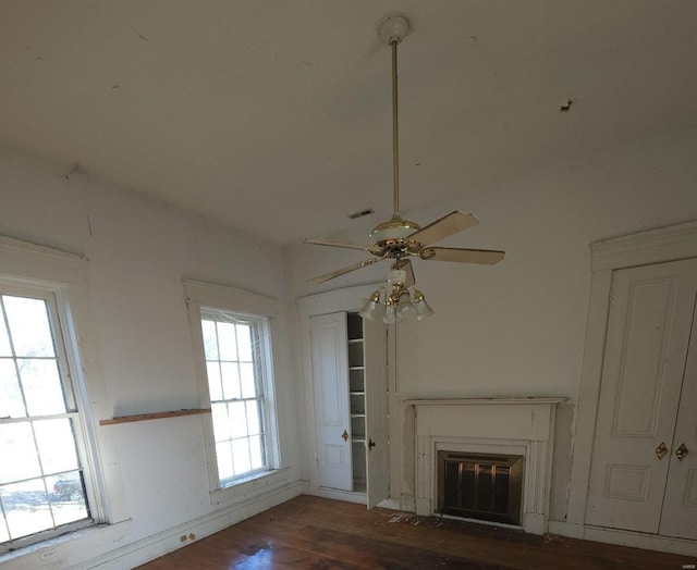 unfurnished living room with ceiling fan and dark hardwood / wood-style floors