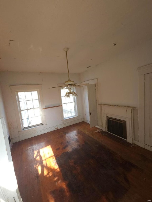 unfurnished living room featuring ceiling fan and wood-type flooring