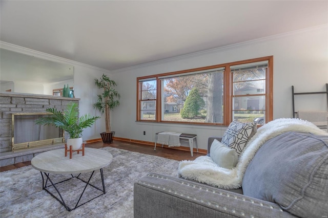 living room featuring hardwood / wood-style floors, a stone fireplace, and crown molding