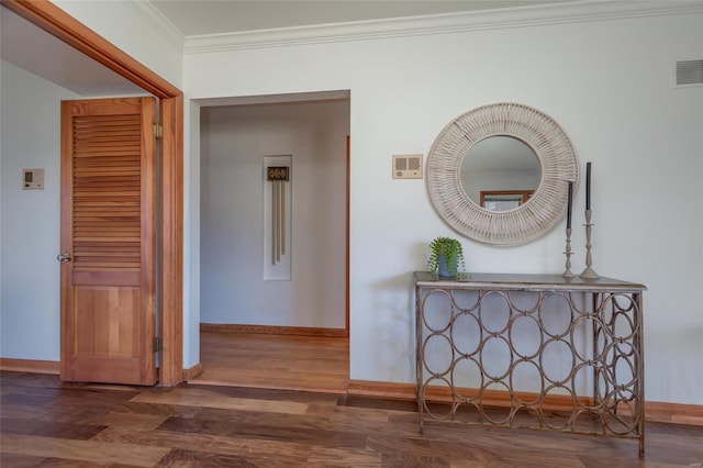 corridor with dark hardwood / wood-style floors and ornamental molding