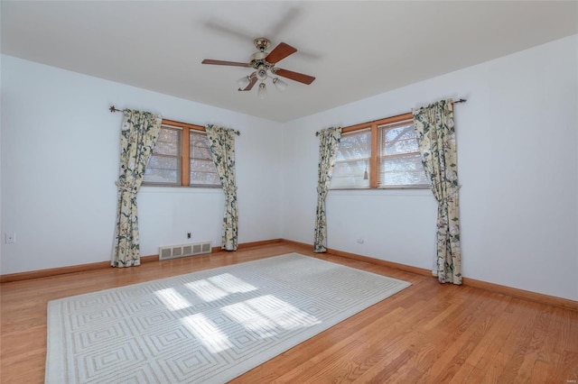 spare room with ceiling fan and light wood-type flooring