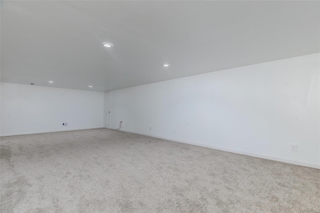 spare room featuring light colored carpet