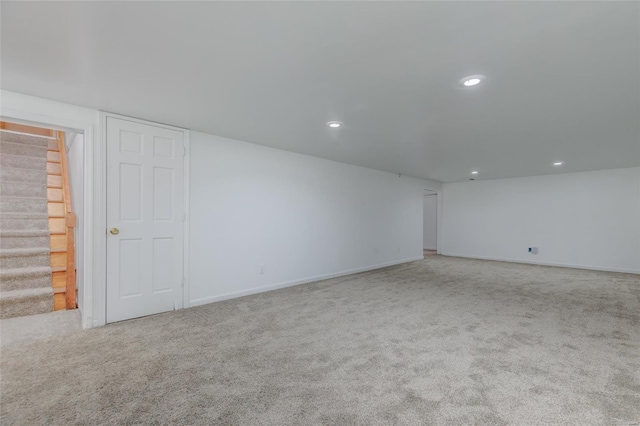 basement featuring light colored carpet