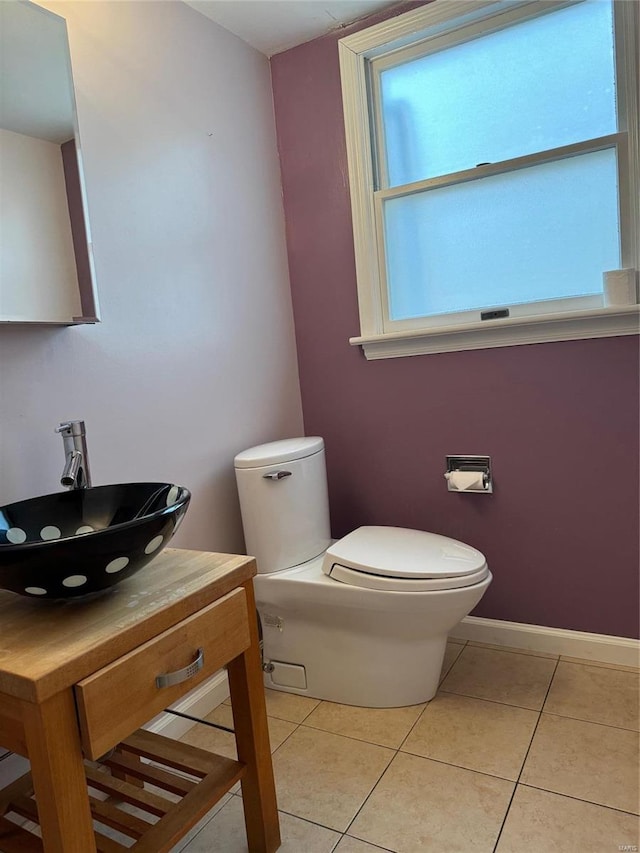 bathroom featuring toilet, vanity, and tile patterned floors