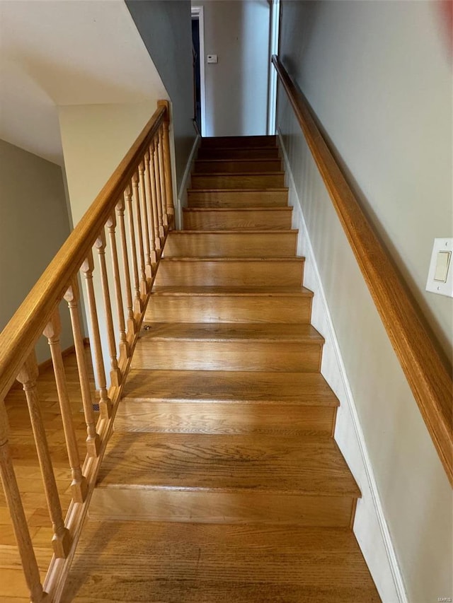 stairway featuring hardwood / wood-style floors