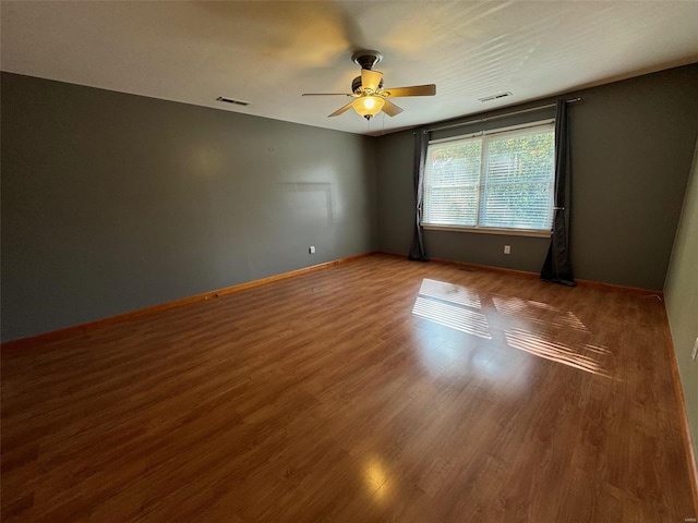 empty room featuring wood-type flooring and ceiling fan