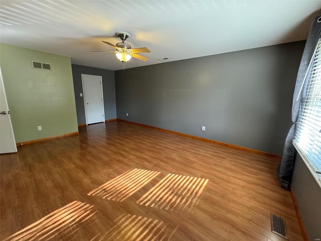 empty room featuring wood-type flooring and ceiling fan