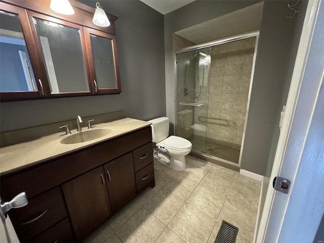 bathroom featuring vanity, tile patterned flooring, toilet, and an enclosed shower