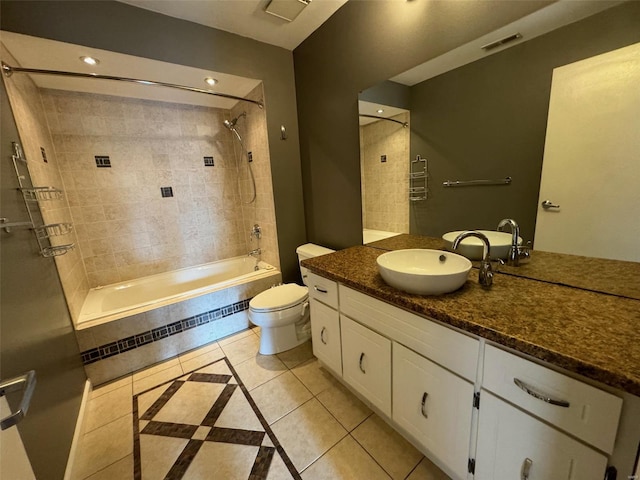 full bathroom with toilet, vanity, tile patterned floors, and tiled shower / bath