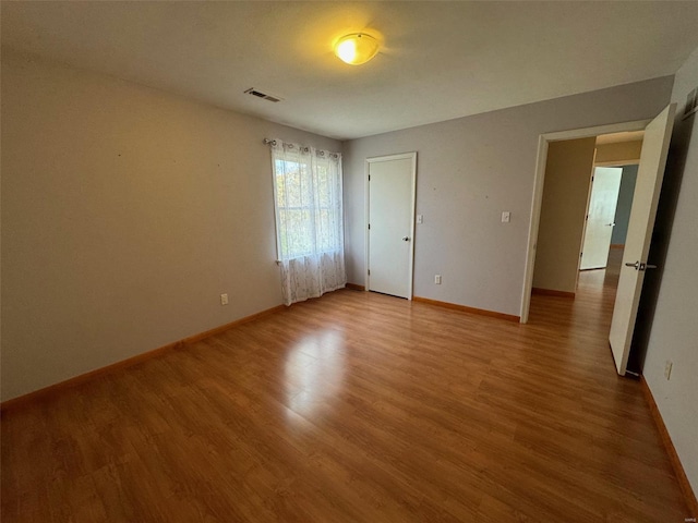 unfurnished bedroom with hardwood / wood-style flooring