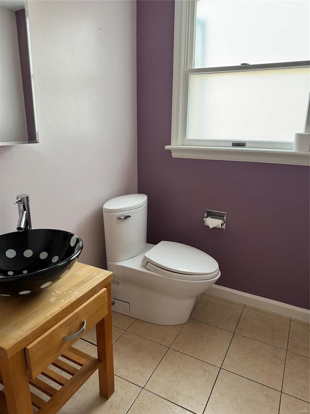 bathroom featuring toilet, vanity, and tile patterned flooring