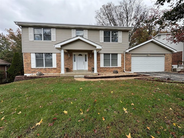 front of property featuring a front lawn, a garage, and covered porch