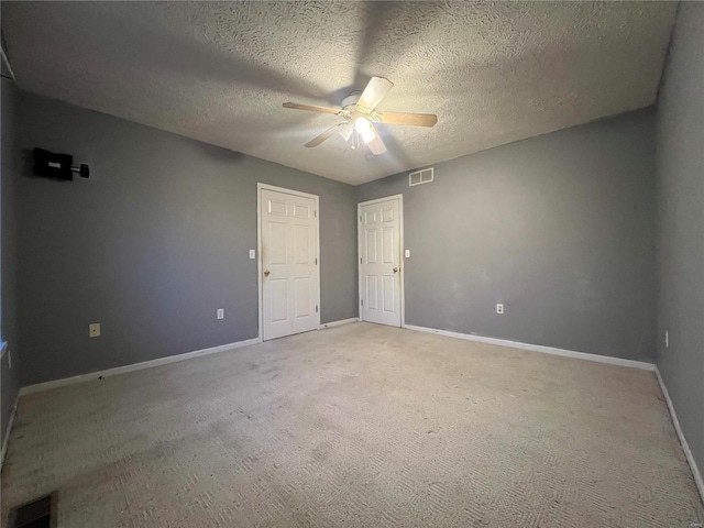 empty room featuring carpet floors, a textured ceiling, and ceiling fan