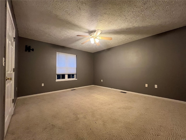 carpeted empty room with a textured ceiling and ceiling fan