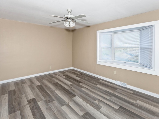 empty room featuring ceiling fan and dark hardwood / wood-style floors