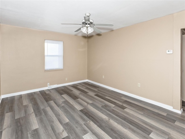 empty room featuring dark hardwood / wood-style floors and ceiling fan