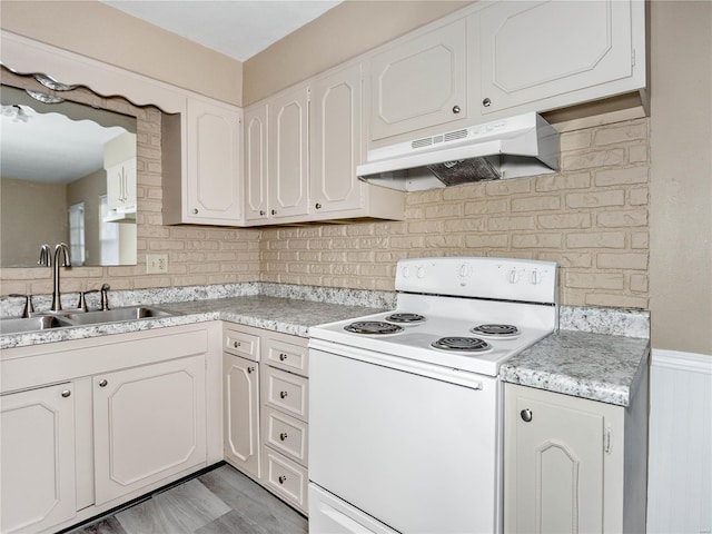 kitchen featuring backsplash, white cabinetry, white electric stove, and sink