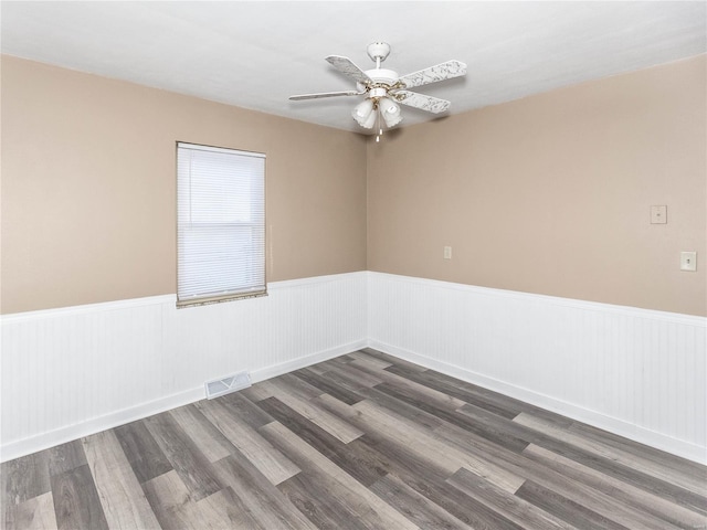 empty room with ceiling fan and dark wood-type flooring