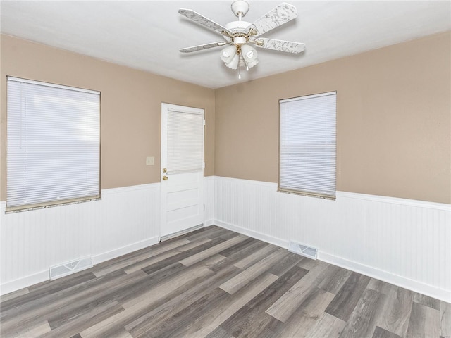 unfurnished room featuring dark hardwood / wood-style floors and ceiling fan