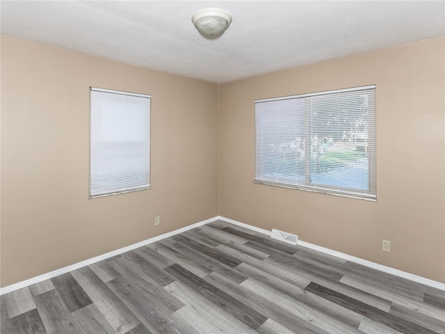 unfurnished room featuring hardwood / wood-style flooring