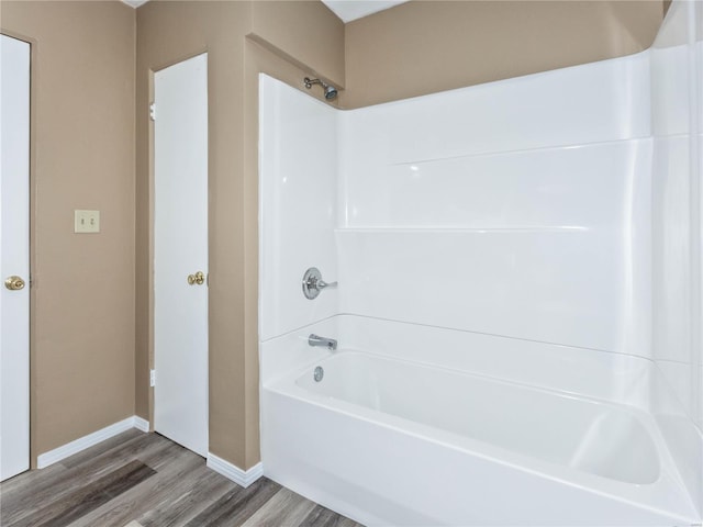 bathroom featuring  shower combination and hardwood / wood-style flooring