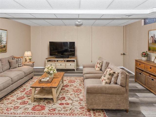 living room featuring a paneled ceiling and hardwood / wood-style floors