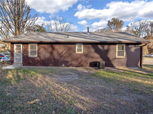 rear view of house featuring central AC