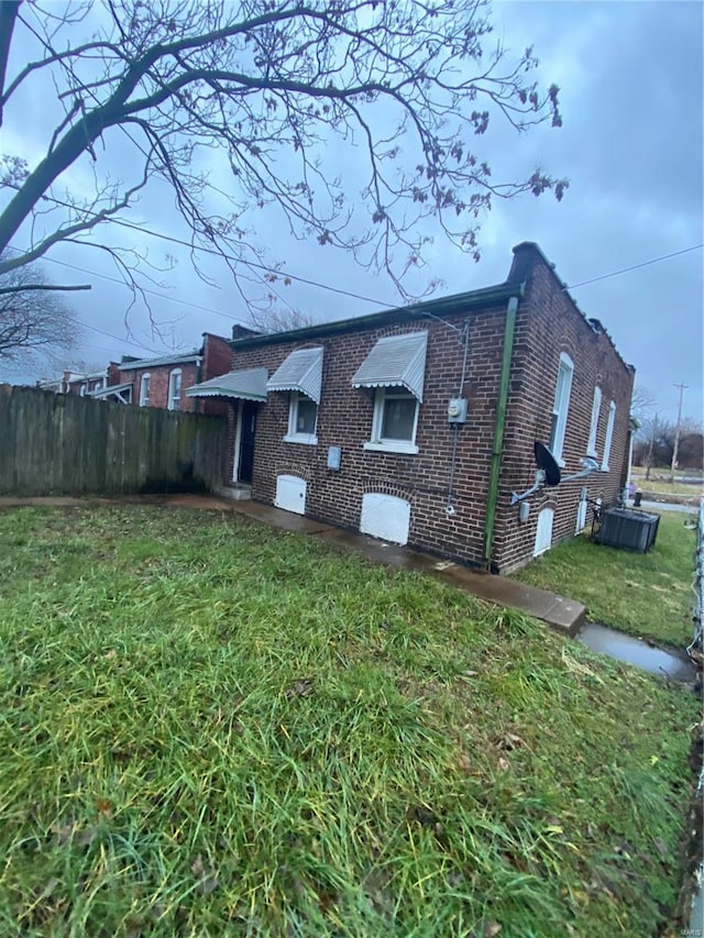 view of home's exterior featuring cooling unit and a yard