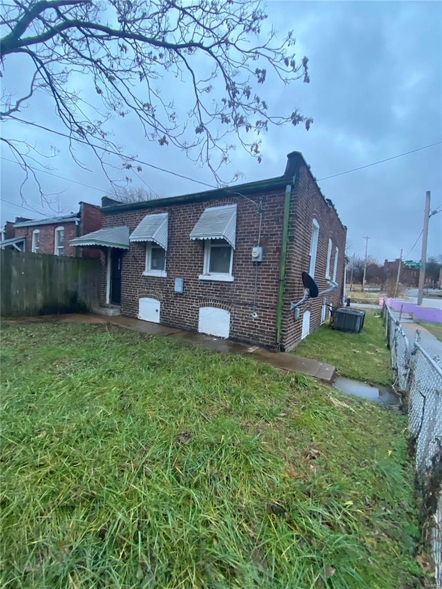 view of side of home featuring a yard