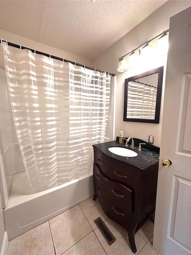 bathroom with vanity, tile patterned flooring, a textured ceiling, and shower / bath combination with curtain