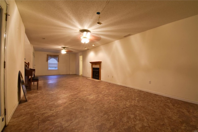 unfurnished living room featuring a textured ceiling and ceiling fan