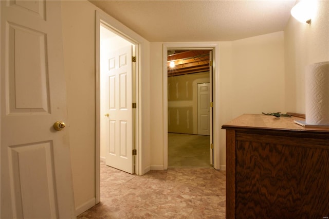 hall with a textured ceiling