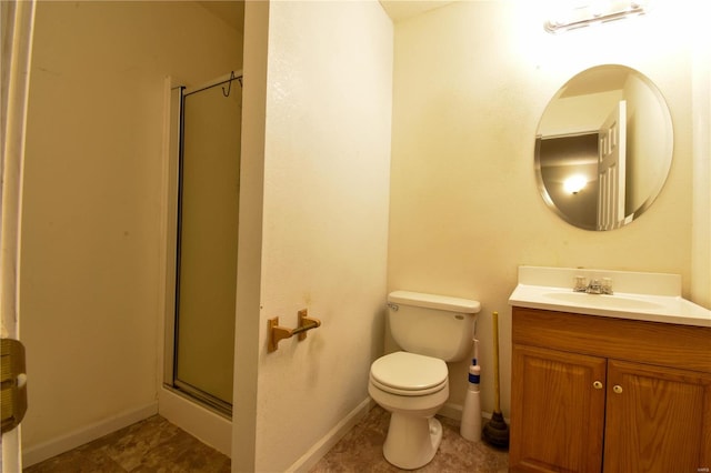 bathroom featuring tile patterned flooring, vanity, toilet, and a shower with door