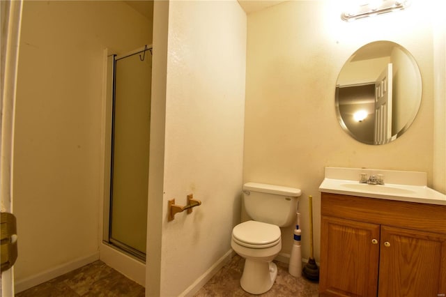 bathroom featuring tile patterned floors, vanity, toilet, and a shower with door