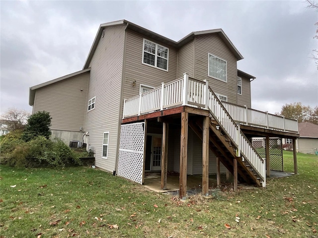 rear view of house with a deck and a yard